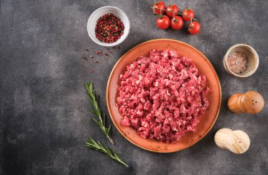 Fresh Raw mince, Minced beef, ground meat with herbs and spices in plate, top view