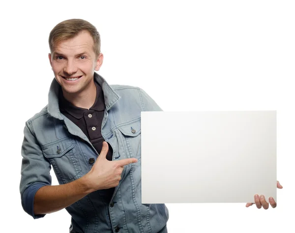 Young man holding a whiteboard. Concept - a demonstration of ach — Stock Photo, Image