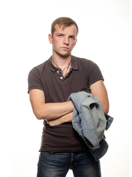 Confident young man with a denim vest in the hands on a white ba — Stock Photo, Image