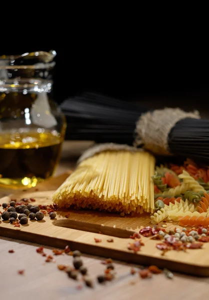 Different kinds of pasta on the wooden background. — Stock Photo, Image