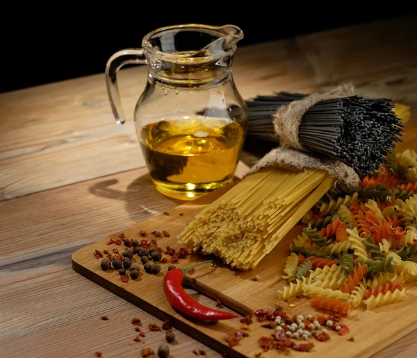 Different kinds of pasta on the wooden background. — Stock Photo, Image