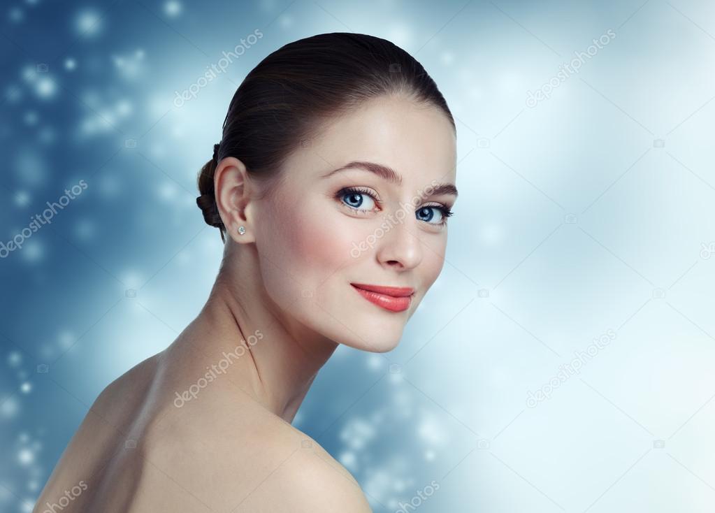 Portrait of a beautiful young girl model with clean skin and blu