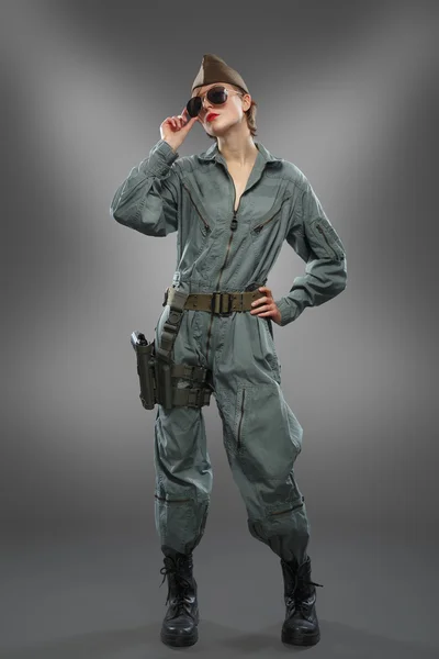 Sexy girl dressed as a helicopter pilot posing in sunglasses — Stock Photo, Image