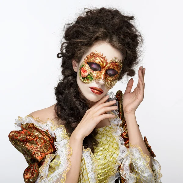 Venetian mask. Beautiful woman in vintage dress and a mask on hi — Stock Photo, Image