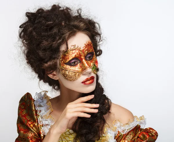 Venetian mask. Beautiful woman in vintage dress and a mask on hi — Stock Photo, Image