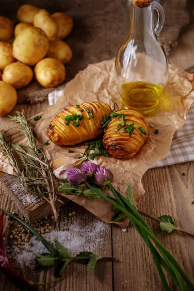 Sliced baked potatoes over wooden background. — Stock Photo, Image