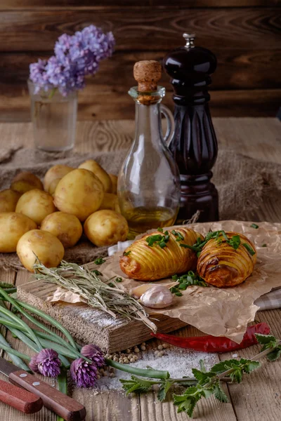 Sliced baked potatoes over wooden background. — Stock Photo, Image