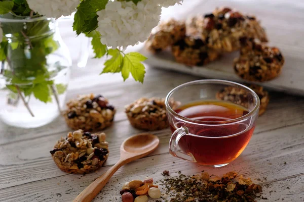 Csésze tea és a cookie-kat, diót és a mazsolát készült. — Stock Fotó