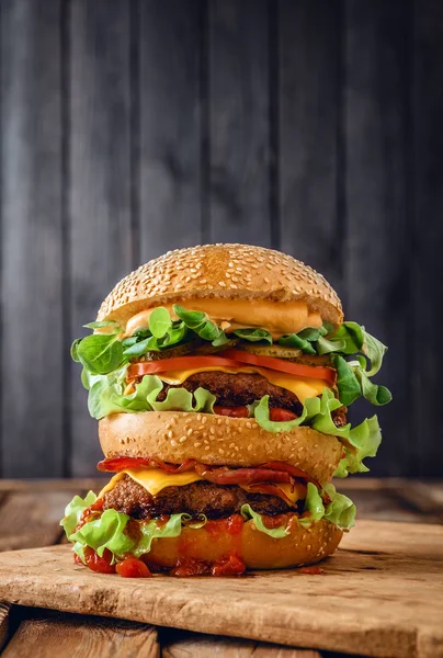 Ev duble burger üzerinde ahşap arka plan yaptı.
