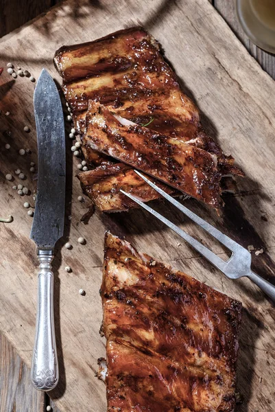 Deliciosas costelas de churrasco na mesa de madeira — Fotografia de Stock