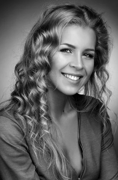 Smiling blonde with long curly hair. — Stock Photo, Image