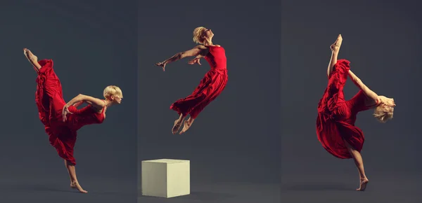 Gorgeous young ballet dancer wearing red dress over dark grey ba — Stok fotoğraf