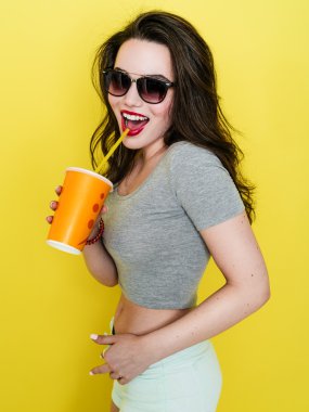 Attractive Caucasian joyful woman with a paper cup of juice