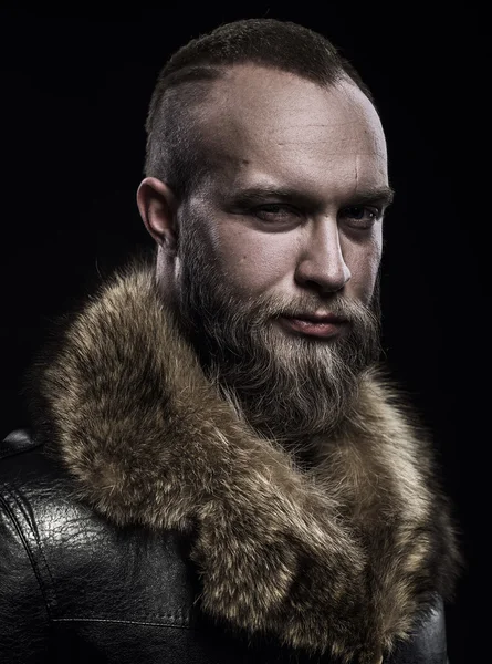 Brutal handsome glum unshaven man with long beard and moustache — Stock Photo, Image