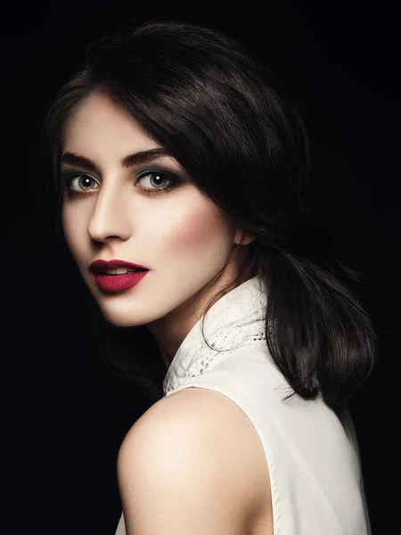 Closeup portrait of elegant young woman over dark background. — Stock Fotó