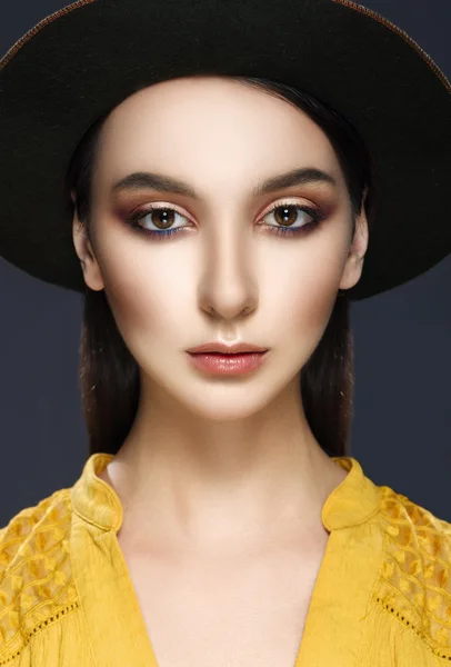 Closeup Portrait of a beautiful girl in the hat on a gray backgr — Stock Fotó