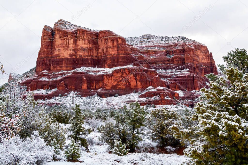 Courthouse Butte in Sedona Arizona After a Snowstorm Close Up. Courthouse Butte in Sedona, Arizona surrounded by fresh snow close up. Sedona sandstone cliffs and high desert juniper and pines in the winter landscape. Sedona Winter. 