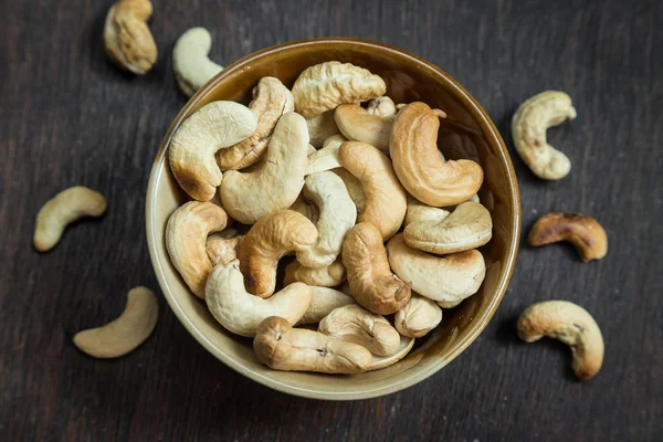 Bowl of cashew nuts from above. On wood background. Stock Image