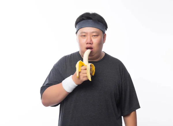 Ung Asiatisk Rolig Fet Idrottsman Äter Banan Isolerad Vit Bakgrund — Stockfoto