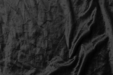 Soyut siyah kumaş kumaş dokusu arka plan veya sıvı dalga veya dalgalı kıvrımlar.