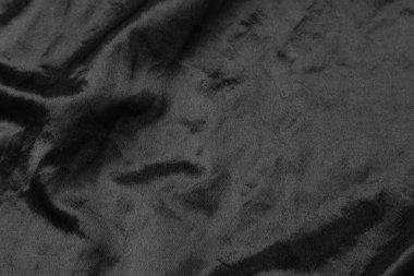 Soyut siyah kumaş kumaş dokusu arka plan veya sıvı dalga veya dalgalı kıvrımlar.