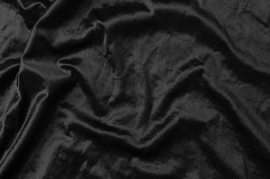 Soyut siyah kumaş kumaş dokusu arka plan veya sıvı dalga veya dalgalı kıvrımlar.
