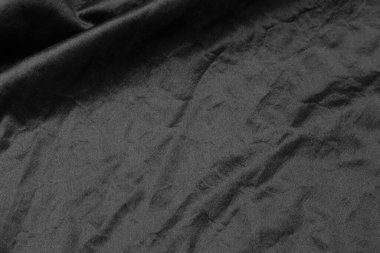 Soyut siyah kumaş kumaş dokusu arka plan veya sıvı dalga veya dalgalı kıvrımlar.