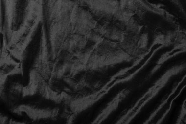 Soyut siyah kumaş kumaş dokusu arka plan veya sıvı dalga veya dalgalı kıvrımlar.