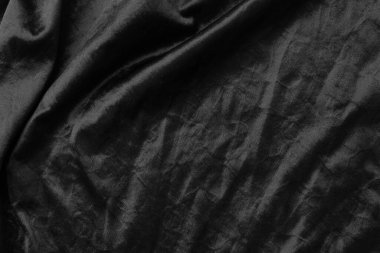 Soyut siyah kumaş kumaş dokusu arka plan veya sıvı dalga veya dalgalı kıvrımlar.