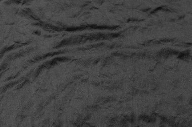 Soyut siyah kumaş kumaş dokusu arka plan veya sıvı dalga veya dalgalı kıvrımlar.