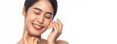 Güzel, genç Asyalı bir kadın beyaz afişte izole edilmiş, elleri birbirine değen taze tenli, temiz bir kadın. Yüz bakımı, kozmetoloji, güzellik ve cilt bakımı konsepti.