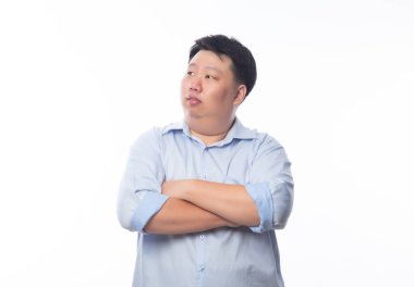 Mavi gömlekli Asyalı şişman adam kollarını kavuşturdu ve beyaz arka planda izole edilmiş kopyasal alan arıyor..