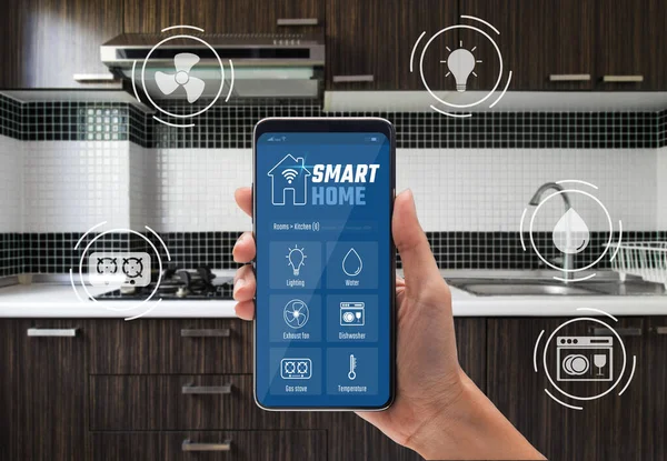 Smart home technology concept, Woman hand using application on smartphone for kitchen controlled with implements icons, Internet of things (IOT), Devices connected in home interior.