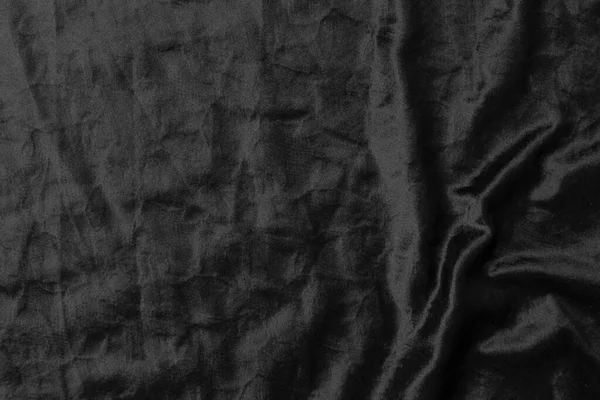 Soyut siyah kumaş kumaş dokusu arka plan veya sıvı dalga veya dalgalı kıvrımlar.