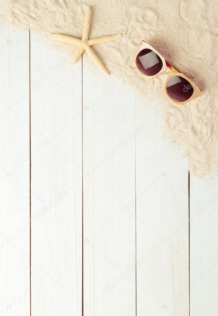 Summer background with beach accessories - sunglasses on white wood table background top view with copy space.