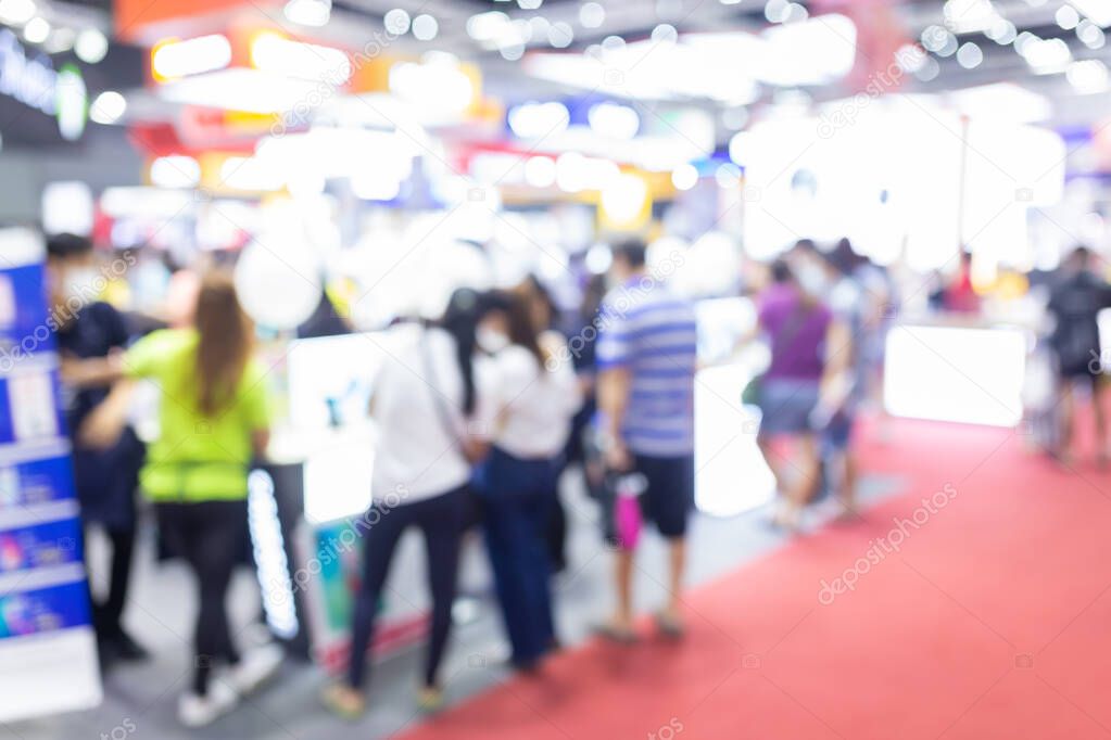 Abstract blur people in exhibition hall event trade show expo background. Business convention show, job fair, or stock market. Organization or company event, commercial trading, or shopping mall marketing advertisement concept.