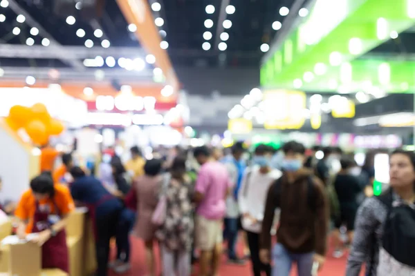 Abstract blur people in exhibition hall event trade show expo background. Business convention show, job fair, or stock market. Organization or company event, commercial trading, or shopping mall marketing advertisement concept.