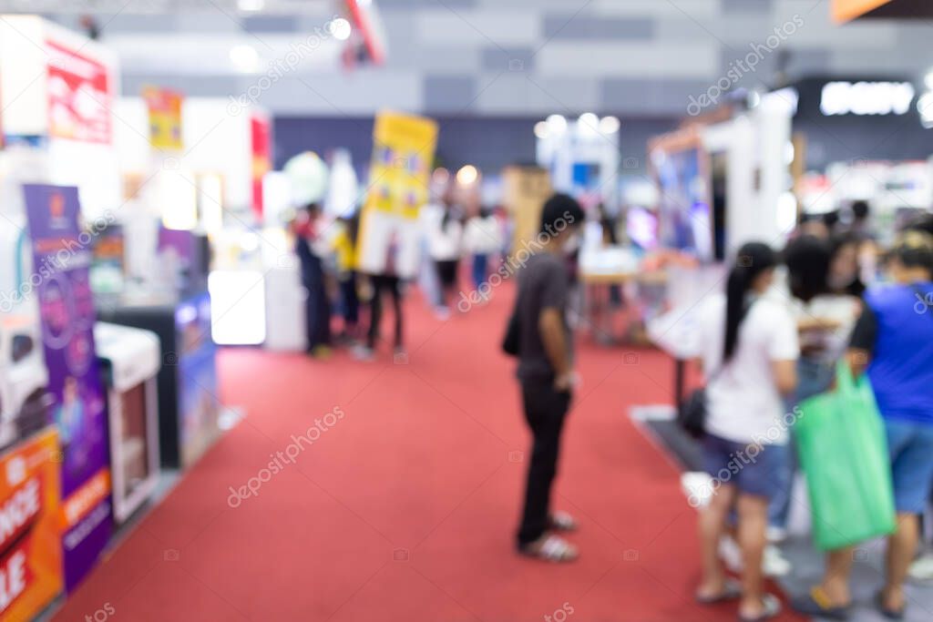 Abstract blur people in exhibition hall event trade show expo background. Business convention show, job fair, or stock market. Organization or company event, commercial trading, or shopping mall marketing advertisement concept.