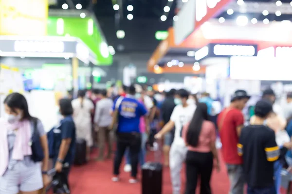 Abstract blur people in exhibition hall event trade show expo background. Business convention show, job fair, or stock market.