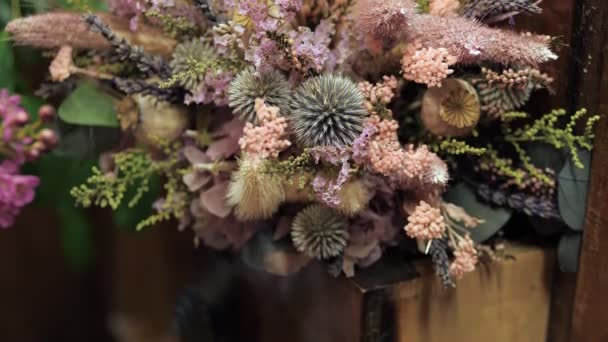 Dried globe thistle in a bouquet. Floral assortment in a shop — Stock Video