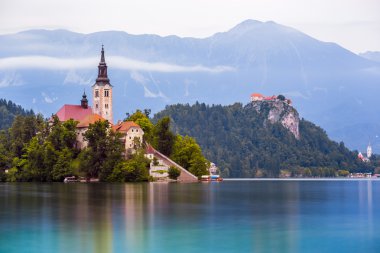 Catholic Church on Island and Bled Castle on Bled Lake clipart