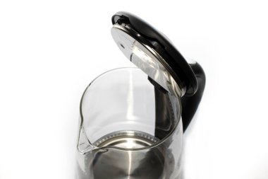The kettle is glass with a close-up lid. the concept of cleaning the heating element and caring for the kitchen appliances.