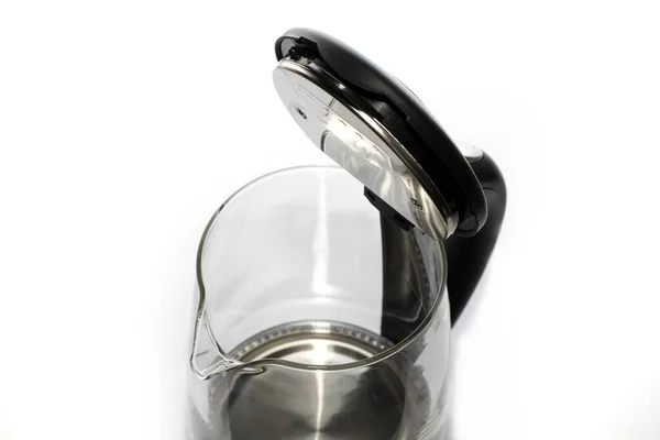 The kettle is glass with a close-up lid. the concept of cleaning the heating element and caring for the kitchen appliances.