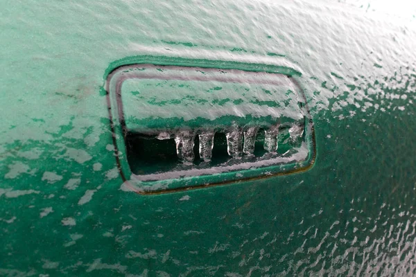 the handle of the car is ice-bound in winter. concept of offspring of vehicle drills by special services