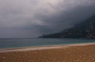 Cirali köyündeki sahilde sabah. Akdeniz 'de şafak vakti mavi körfez. Lycian Patikası 'nın manzaraları. Mayıs 2021. Uzun pozlama resmi