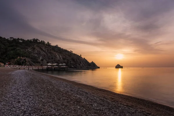 Pintoresco paisaje marino mediterráneo en Turquía. Colorido amanecer en una pequeña bahía cerca de la aldea de Tekirova, distrito de Kemer, provincia de Antalya. Foto de larga exposición. — Foto de Stock
