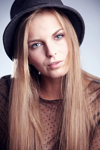 Beautiful young blonde woman in a hat — Stock Photo, Image