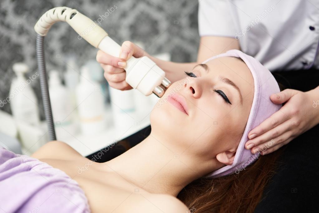 woman face treatment in medical spa center 