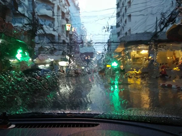 heavy raining is on a car windscreen in the evening