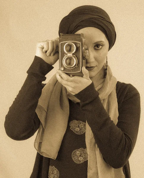 Young Woman holding old camera in hijab and scarf — Stock Photo, Image